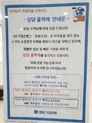 서울에 위치한 IBK기업은행 영업점 입구에 부착된 코로나19 긴급대출 상담 관련 홀짝제 도입 안내문.